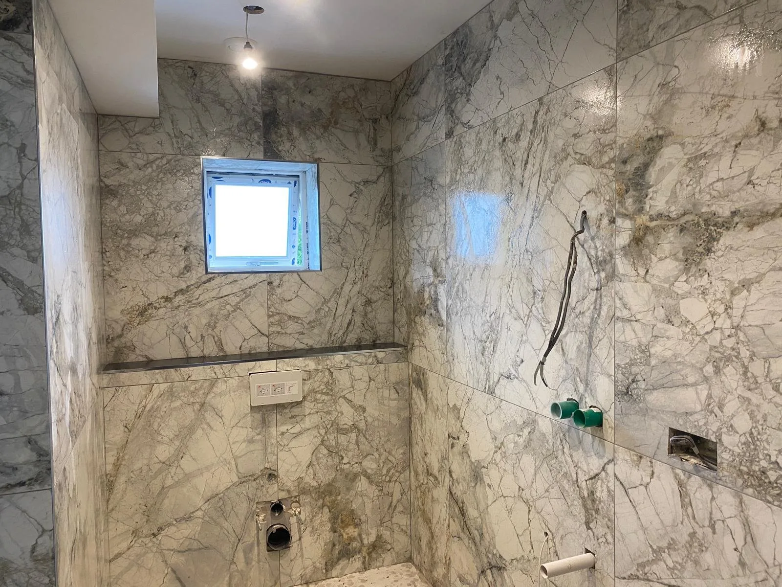 White and grey veined marble shower enclosure