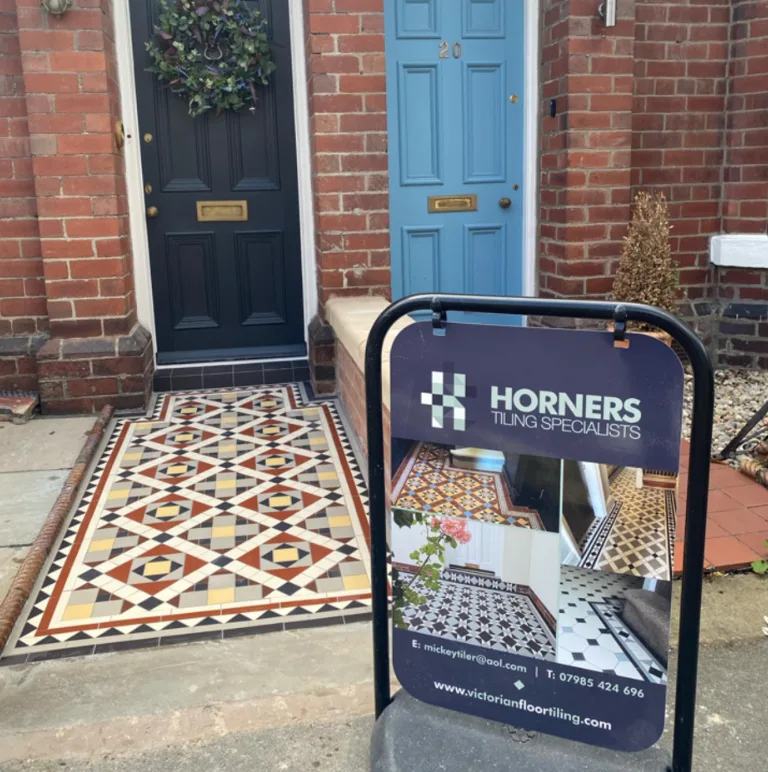 Victorian geometric floor tiles with white brick walls